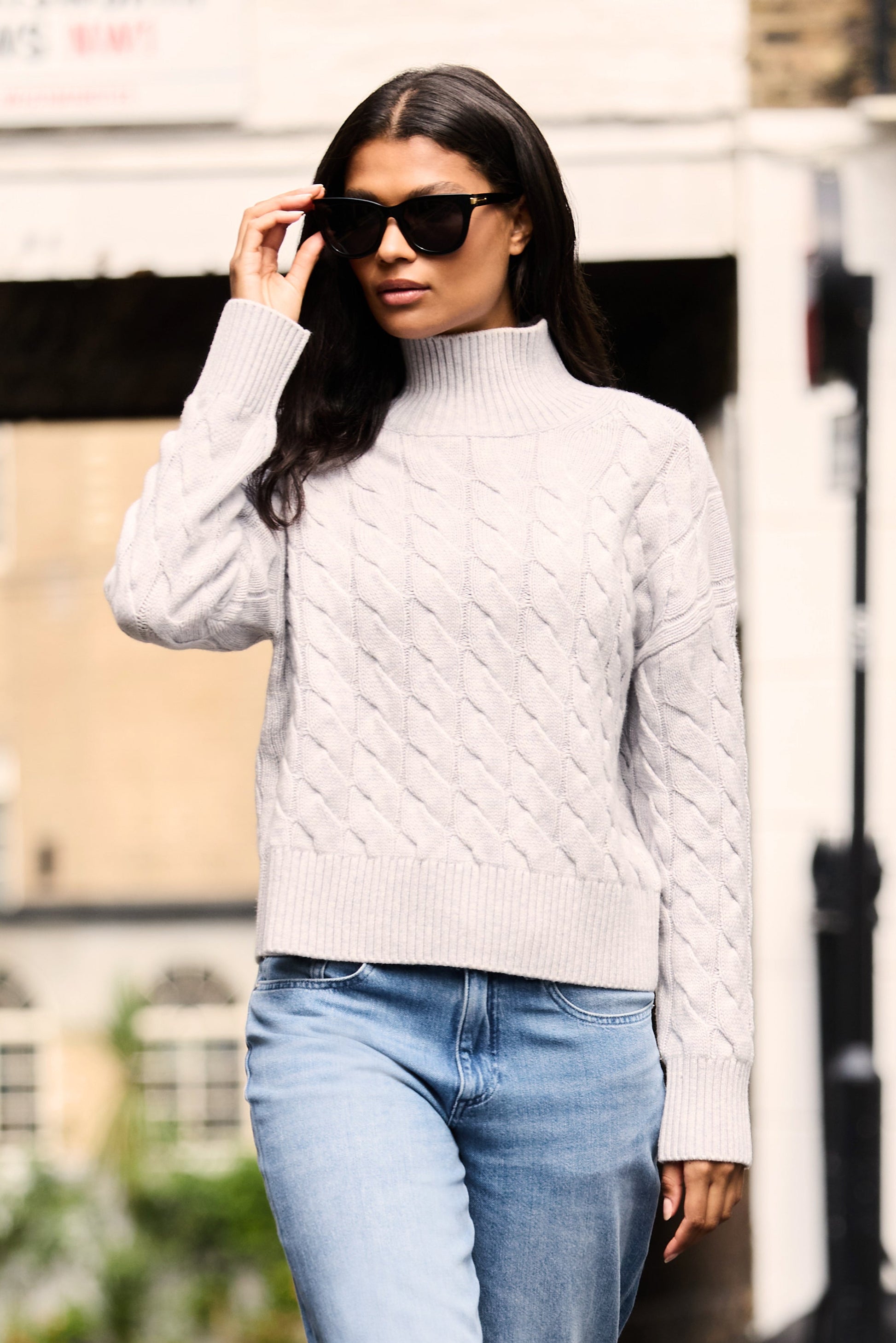 Grey cable knit mock neck jumper made from merino wool and cashmere