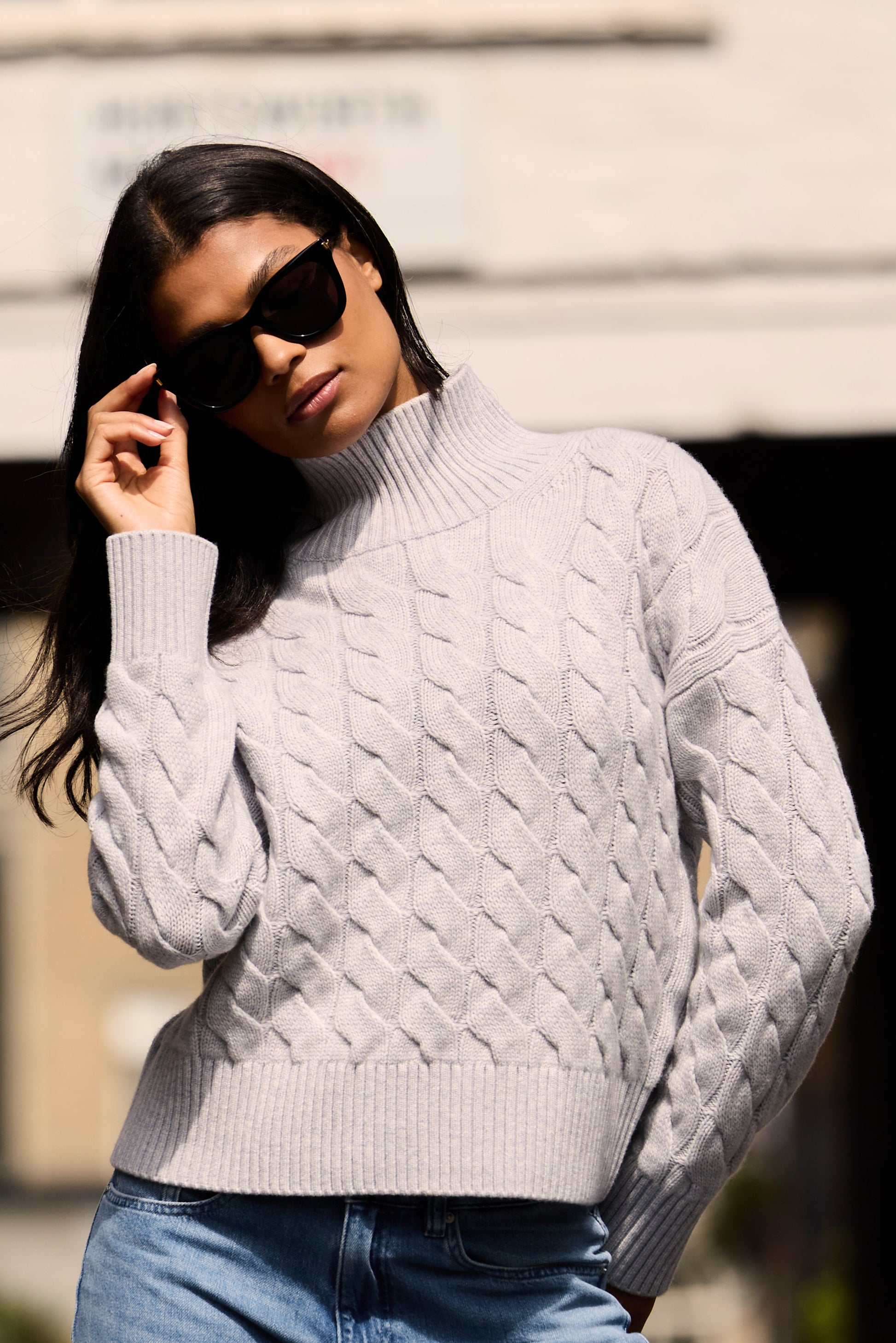Grey cable knit mock neck jumper made from merino wool and cashmere
